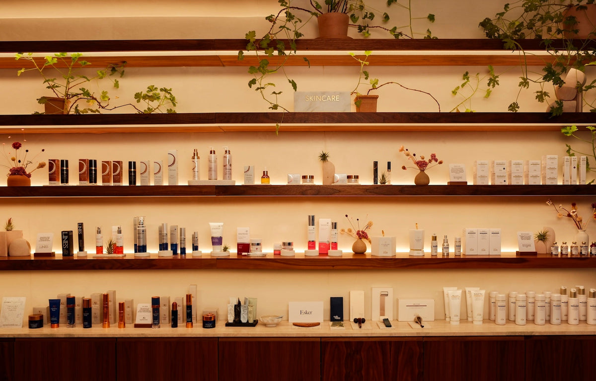 backlit shelf with lots of self-care retail products